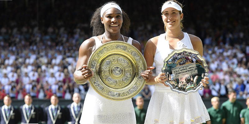 Serena Williams holds her sixth Wimbledon trophy beside Spain's Muguruza