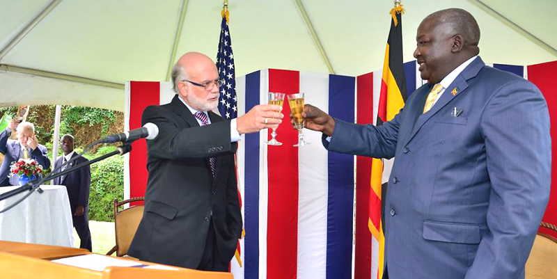 US Ambassador Scott DeLisi and Minister Okello Oryem raise champagne glasses to mark 239 years of America's independence