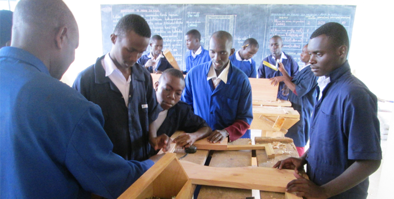 Students having a hands-on experience in wood work