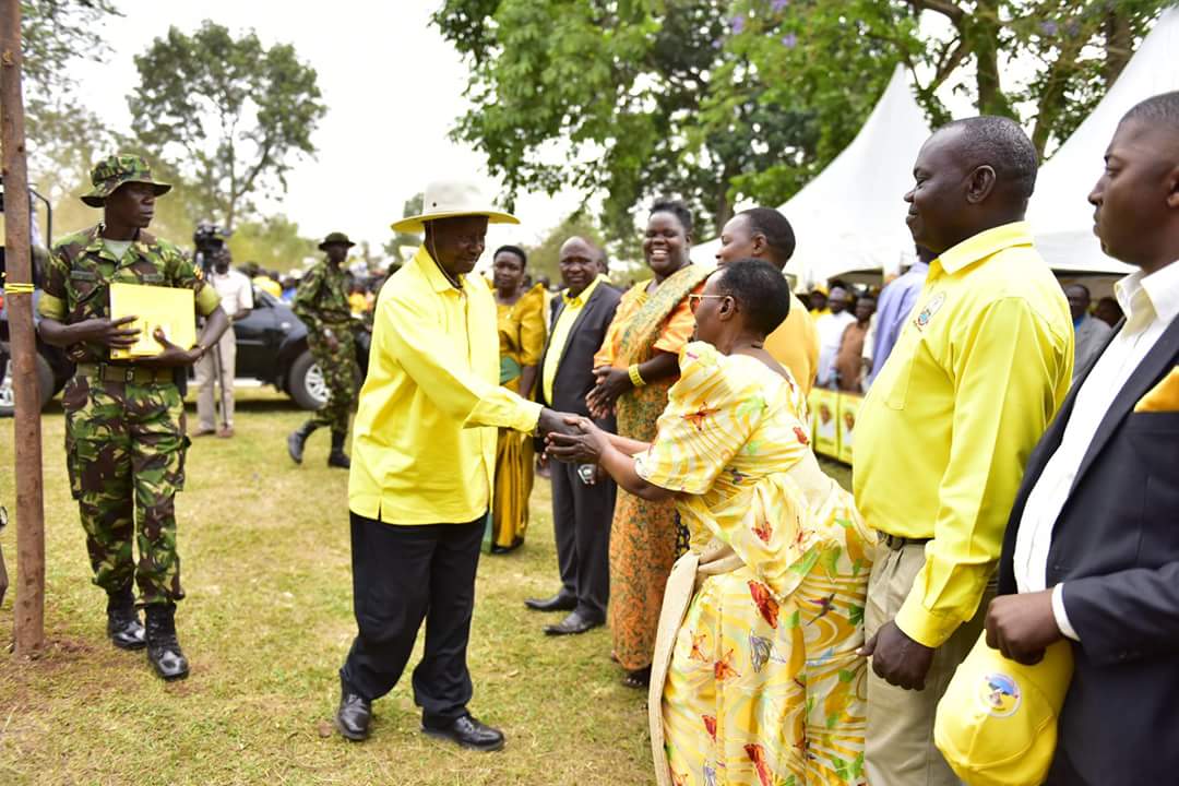 President Museveni greets women on one of his campaign trails