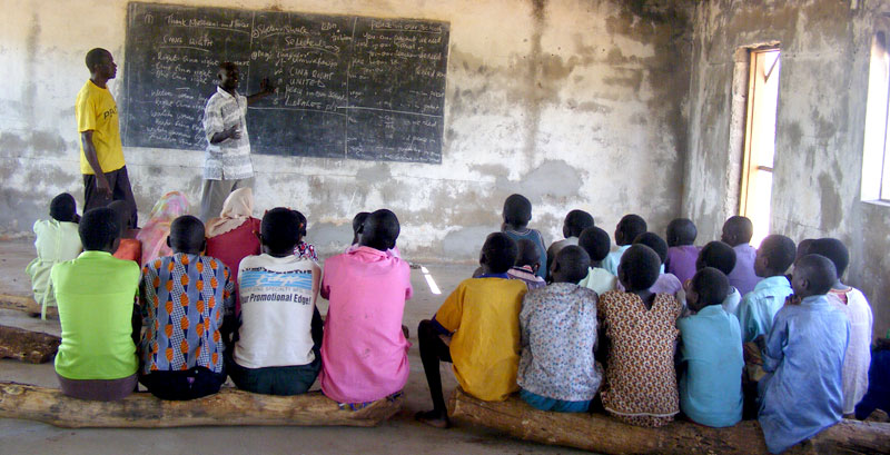 Pupils sit on logs in what is called a Classroom
