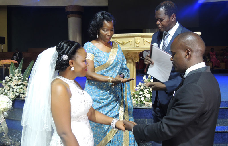 KCCA boss Jennifer Musisi with the bride and groom