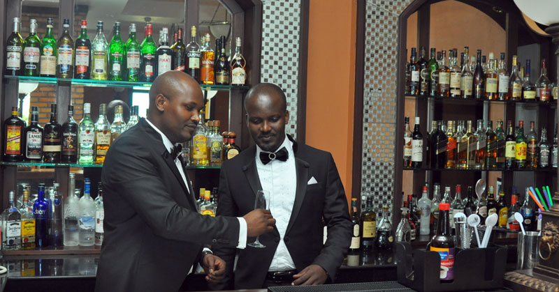 Groom Solomon and bestman David take a photo in the bar