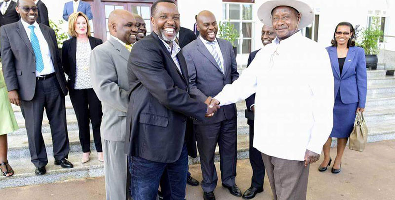 Amos Wekesa shakes hands with president Museveni
