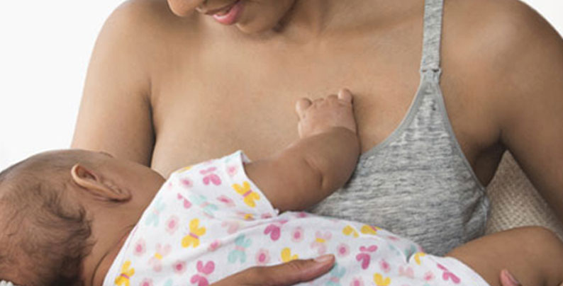 A woman breastfeeds her child