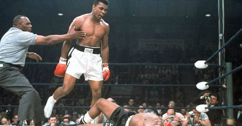 Muhammad Ali stands over fallen challenger Sonny Liston