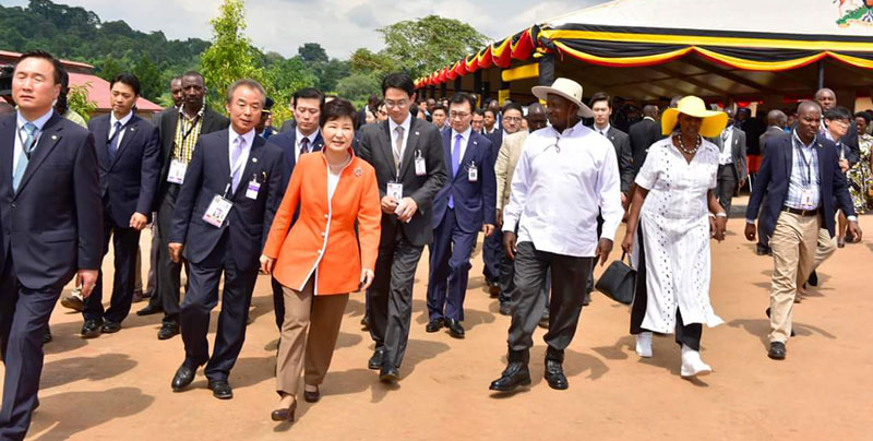 President Park (in Orange jacket) touring National Farmers Leadership Centre at Kampiringisa built by her government