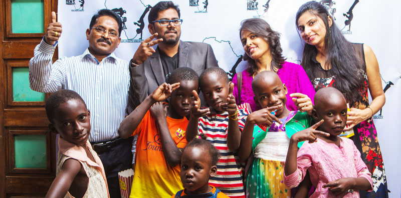Crew kids posing with members of the Indian community