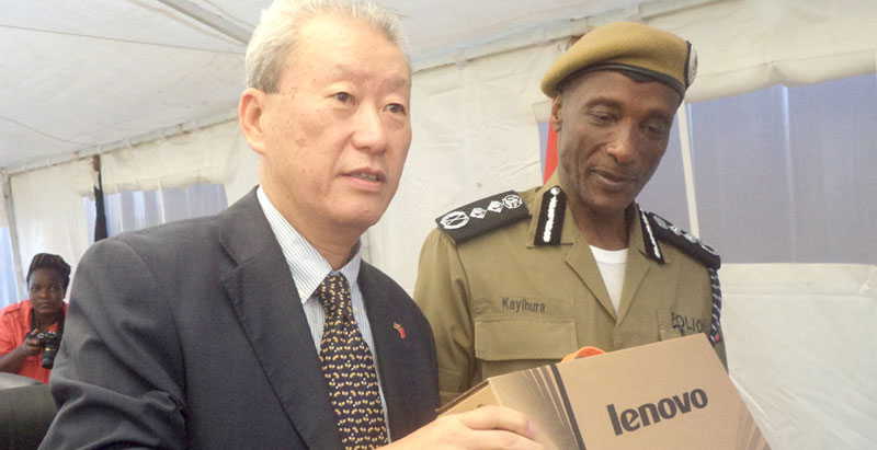 IGP Kale Kayihura receiving one of the laptops from Chinese Ambassador Zhoa Yali this week
