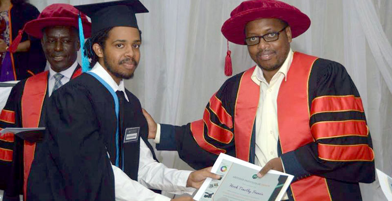A student receives a certificate at the graduation