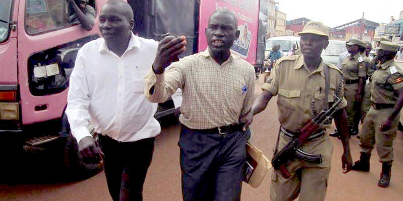 Augustine Ojobile is led to the cells by prison warders