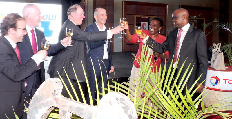 Energy minister Irene Muloni toasts to the launch of the FEED study this week with the executives from the oil sector. Right is Total's GM Adewale Fayemi