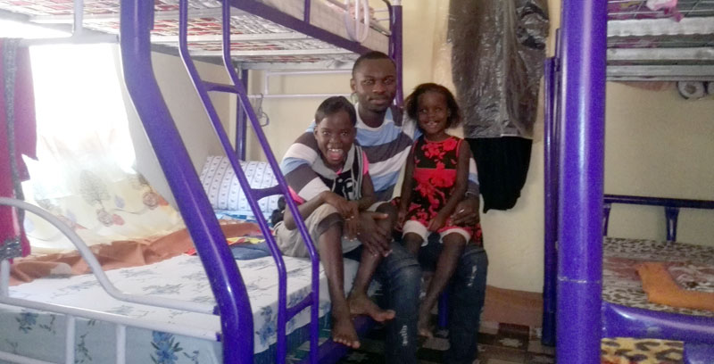 Zion children’s orphanage C.E.O with the children inside their new home.