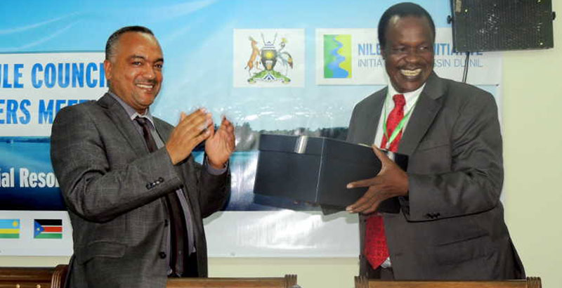 Kebede Gerba, Ethiopia’s Assistant Water and Electricity Minister hands a courtesy gift to his counterpart Sam Cheptoris