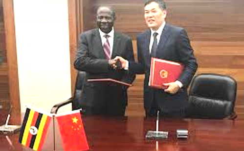 Finance Minister Matia Kasaija (left) signed a grant agreement in Beijing worth (US$30m) with China's Vice Minister for Commerce Dr. Qian Keming
