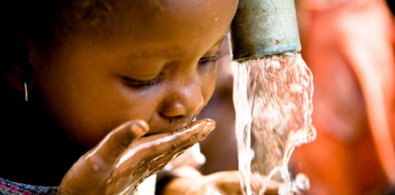 A young girl drinking clean water