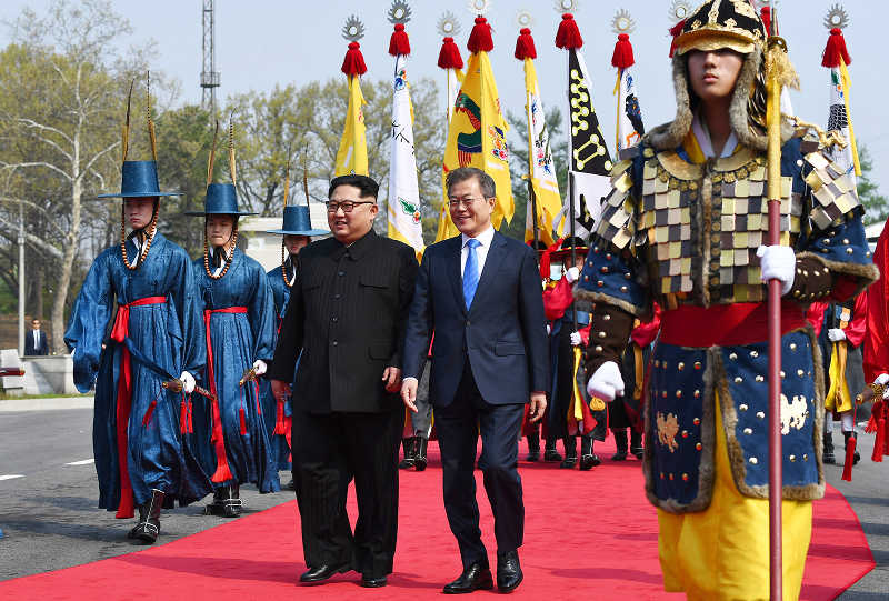 North Korean Leader Kim Jong-Un (left) and his Korean counterpart Moon Jae-in walk shoulder to shoulder at the demilitarized zone, the first such a meeting since the end of the Korean war in 1953 