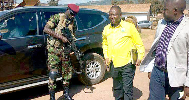 Minister of state for finance David Bahati with his bodyguard