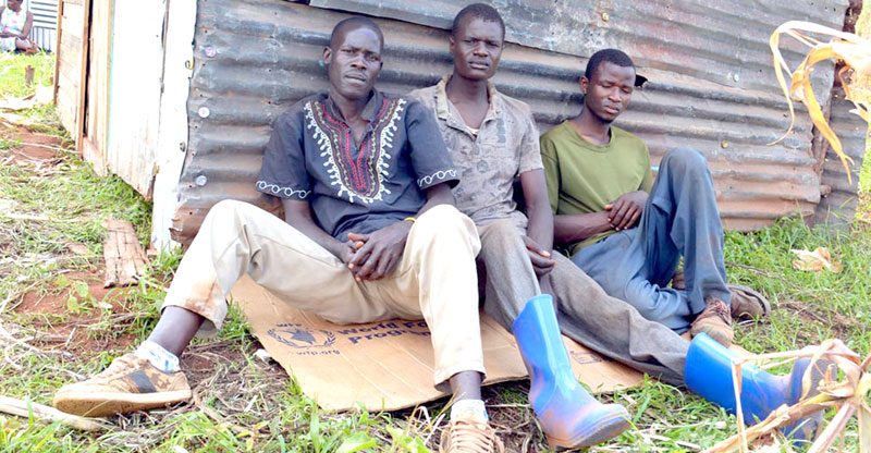 Young men wait for work outside the factory