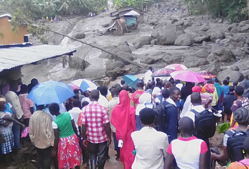 Shocked residents gaze at the huge rocks that were rolled down the hills