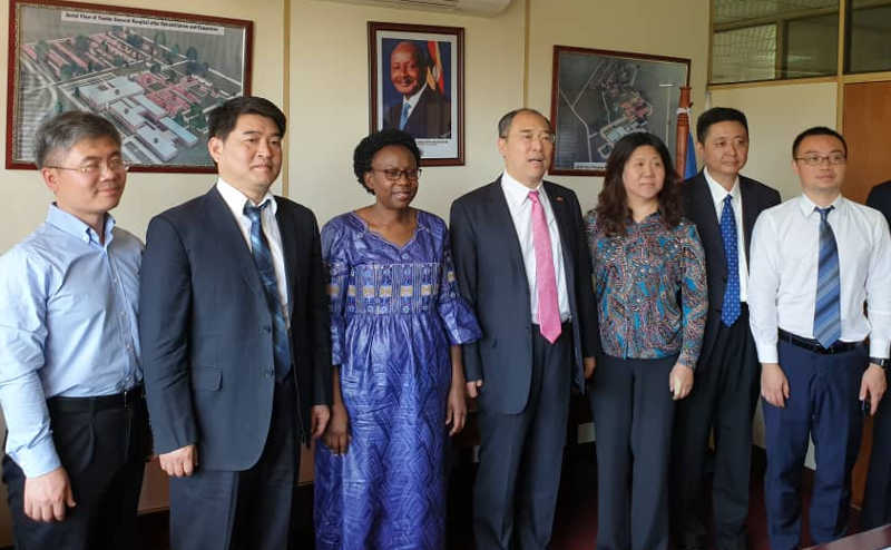 Health Minister Jane Ruth Aceng n blue dress with Chinese delegation at her office 