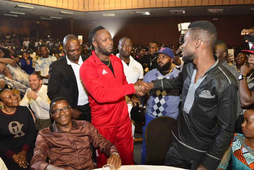 Bebe Cool and Bobi Wine share a handshake