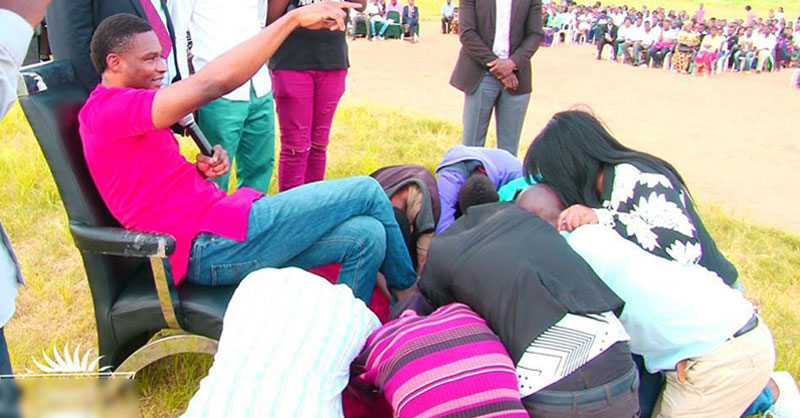 Women scramble to kiss the pastor's feet