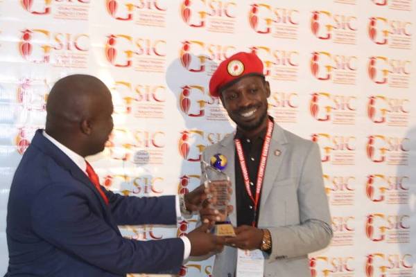 Bobi Wine receives the award after the conference