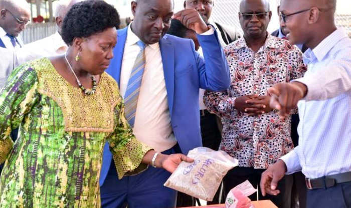 Speaker Kadaga is shown some of the newly released seeds. Agriculture Minister Vincent Ssempijja (in Blue suit) accompanied her for the tour of Namulonge