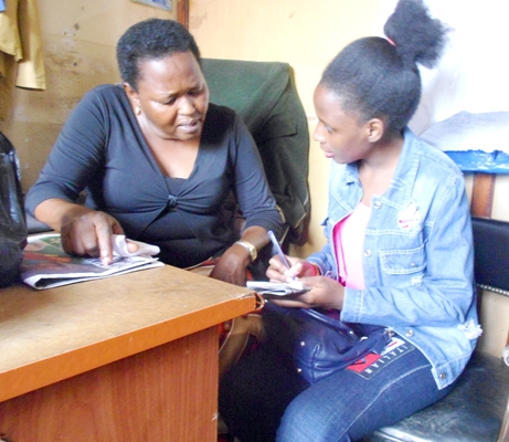 Florence Etadu speaks (l) speaks to Anita Muhanguzi