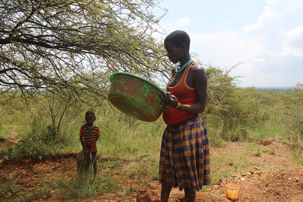 A young girl panning gold