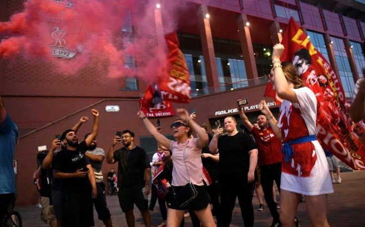 Liverpool fans celebrate their club's victory following a 30-year wait