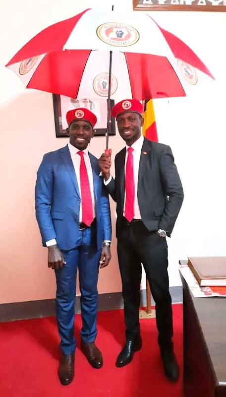 Kyagulanyi aka Bobi Wine and his right hand man Joel Ssenyonyi show off their umbrella symbol