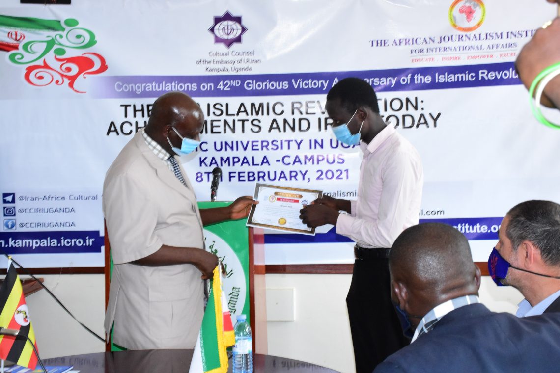 A-student-receives-a-certificate-from-Dr-Lukwago-at-IUIU-1140×760