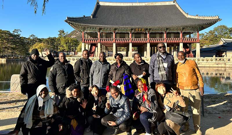 Participants outside the historic Gyeongbokgung Palace