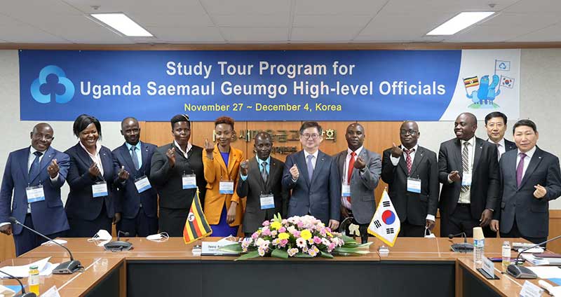 Ugandan delegates in a historic picture with KFCC Vice President (Centre) at the organisation's headquarters in Seoul, South Korea