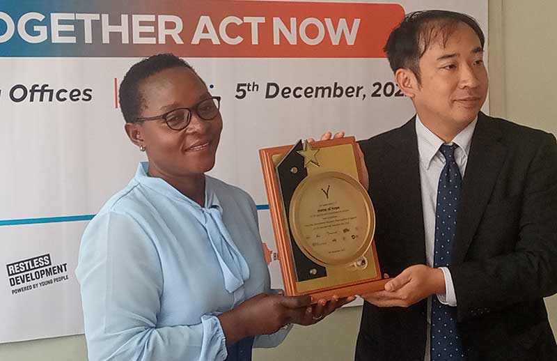 Maama-Edith-Lukabwe-receiving-her-award-2