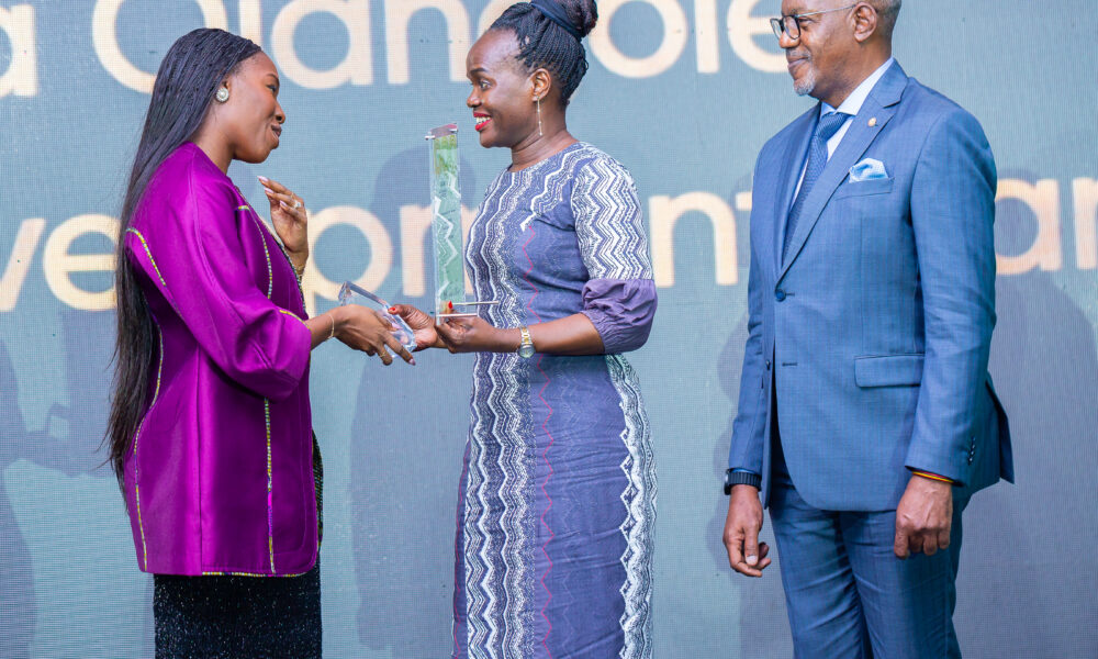Dr.-Ojangole-receives-the-Award-from-Ivorian-sprinter-and-silver-medallist-Murielle-Ahoure-Demps.-Looking-on-is-UDB-Board-Chair-Geoffrey-Kihuguru-R-scaled