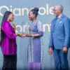 Dr.-Ojangole-receives-the-Award-from-Ivorian-sprinter-and-silver-medallist-Murielle-Ahoure-Demps.-Looking-on-is-UDB-Board-Chair-Geoffrey-Kihuguru-R-scaled