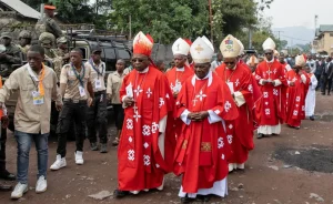 Rebel fighters can be seen on guard on the streets of Goma after a big mass at the cathedral earlier this month to mark the beatification of Kositi