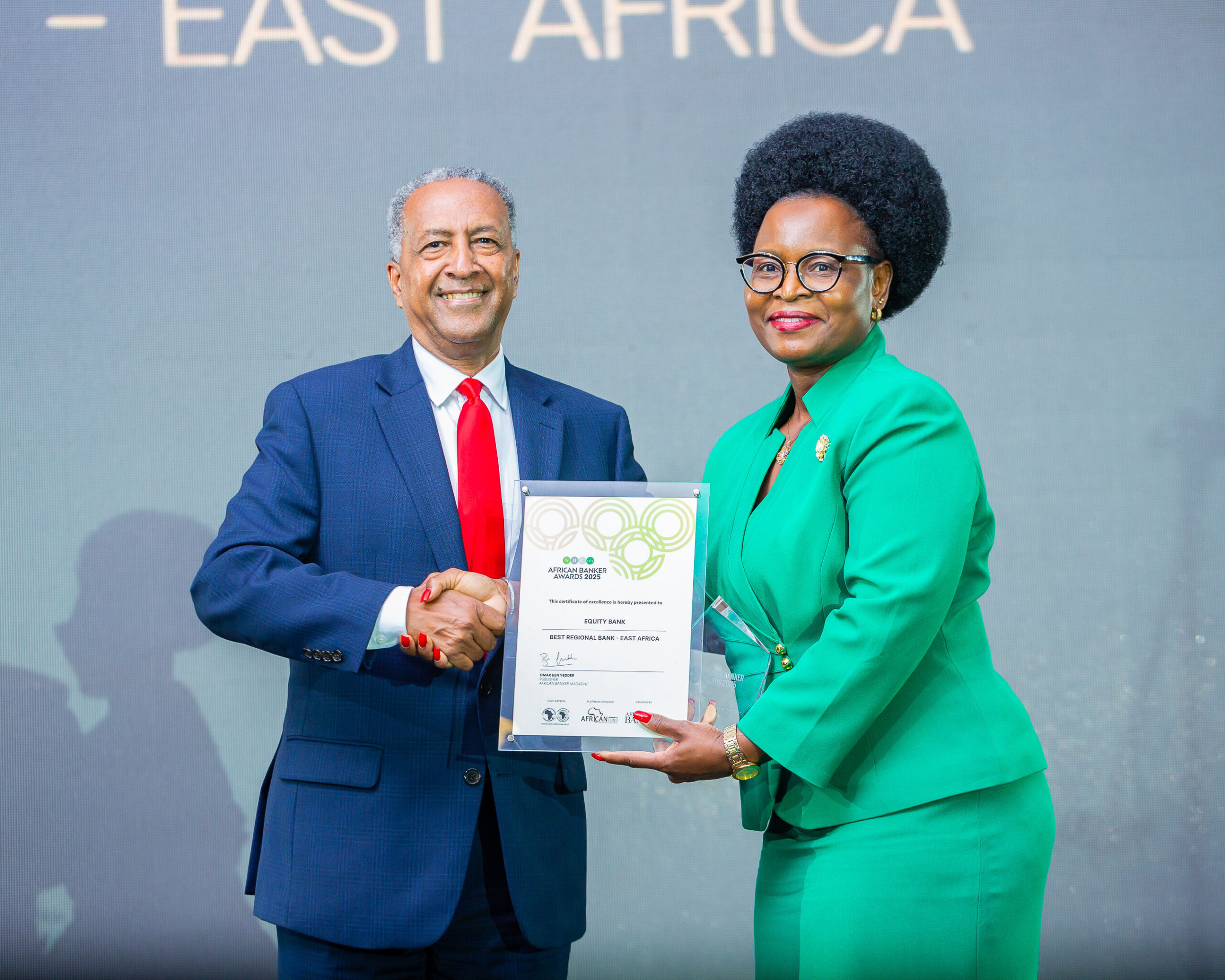 Zemedeneh Negatu, Chairman of the Washington, DC-based capital investment fund, Fairfax Africa Fund, LLC (Left) hands over a...nad of Women and Youth Banking, Dr. Silpah Owich (Right) at the 2025 African Banker Awards held in Abidjan, Côte d’Ivoire
