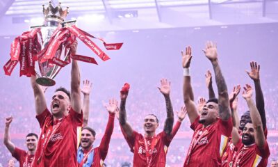 Diogo Jota lifts the Premier League trophy amid Liverpool's celebrations at the end of the 2024/25 season