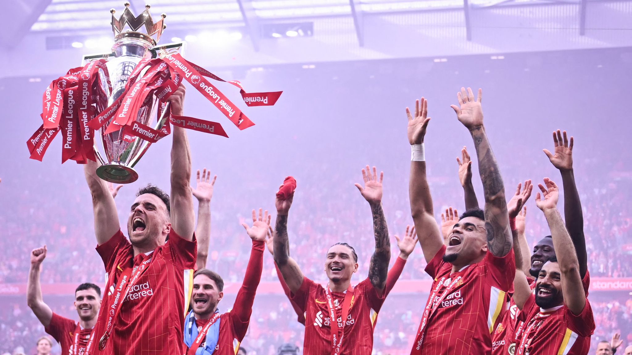 Diogo Jota lifts the Premier League trophy amid Liverpool's celebrations at the end of the 2024/25 season