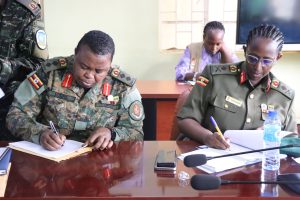 Incoming-DWA-Brig-Gen-Charity-Bainababo-and-Col-Betty-Musuya-signing-the-hand-takeover-report-of-the-DWA-at-MoDVA-mbuya